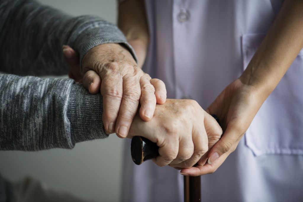 Nurse looking after elderly medical cannabis patient